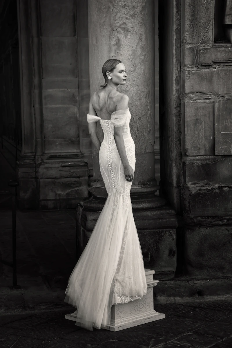 Stock photo: bride in a sculpted white gown with a long train — liquid silk-satin drape and highlight on the body