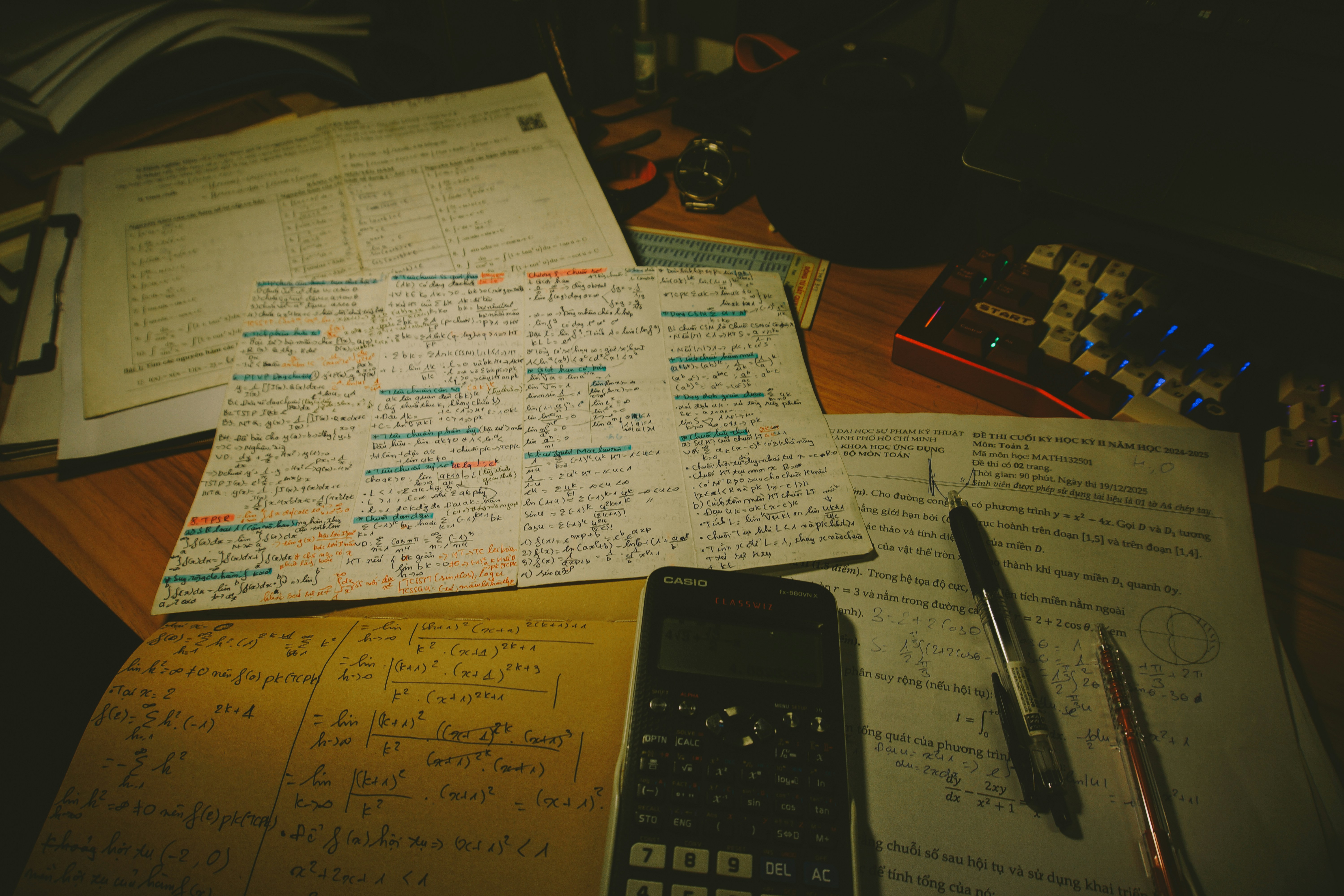 Desk with papers, calculator, and pens