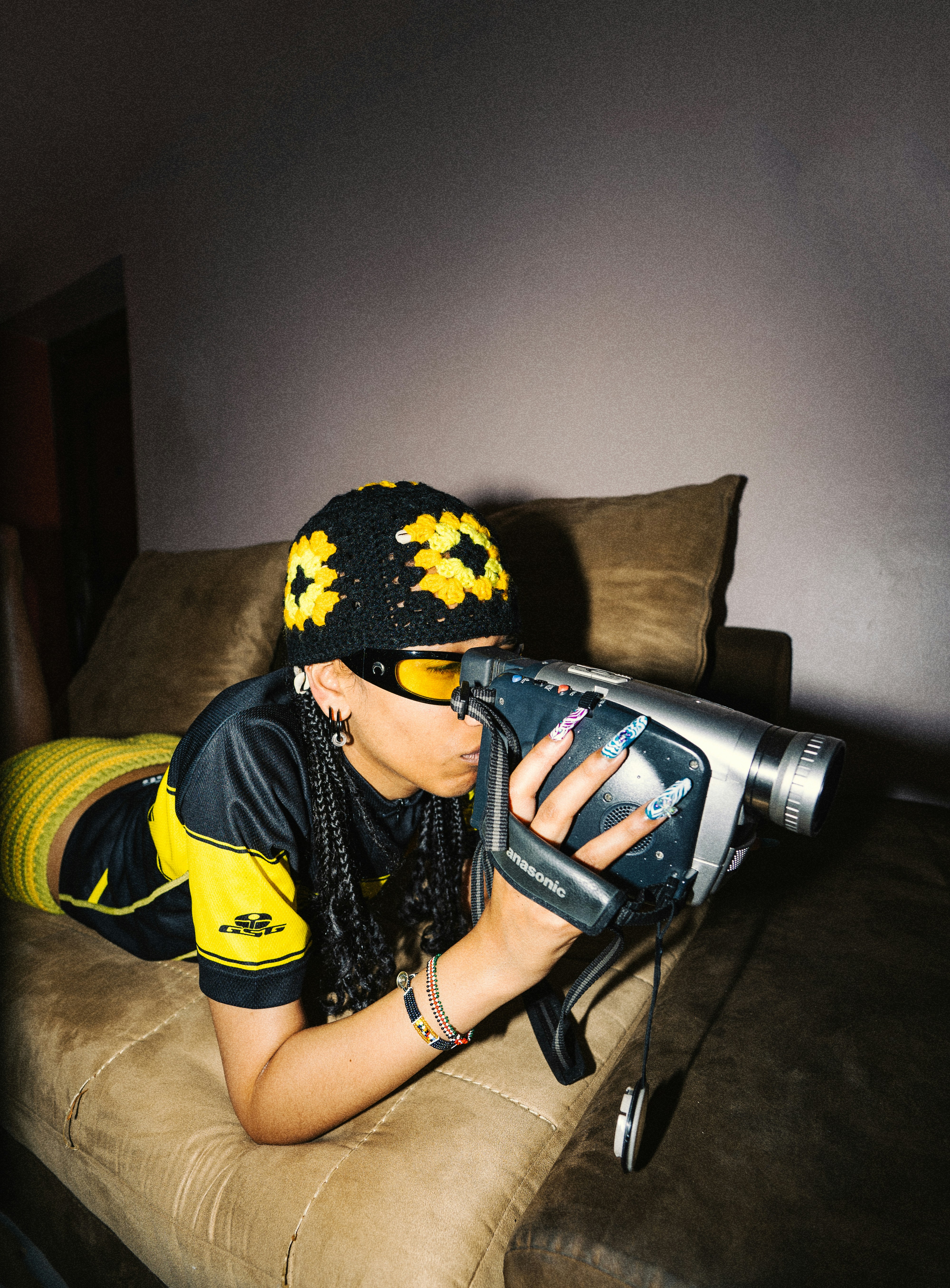 Woman in sunflower hat films with vintage camcorder