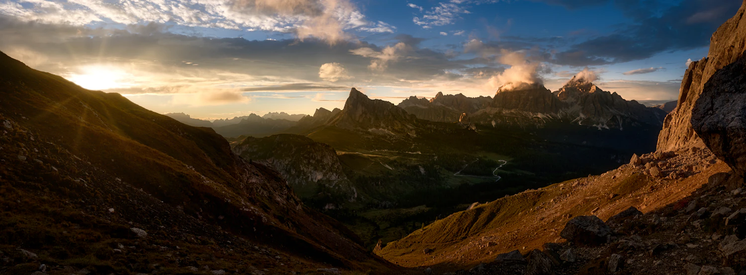 Dolomite peaks lit gold above a dark valley at dusk