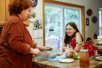Woman preparing food with a girl watching