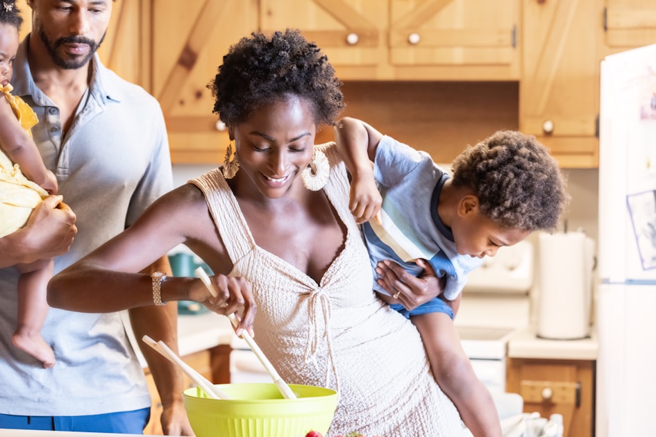 A family cooking together in a warm kitchen