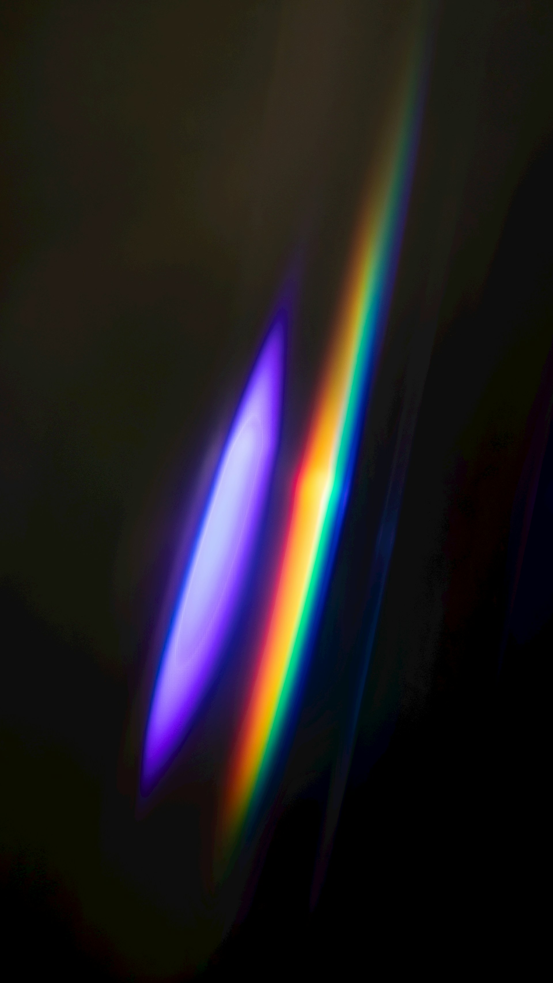 Abstract rainbow light streaks on dark background