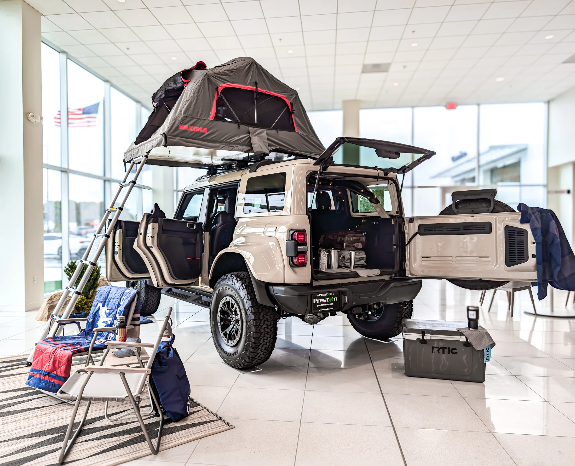 SUV with a rooftop tent set up at camp