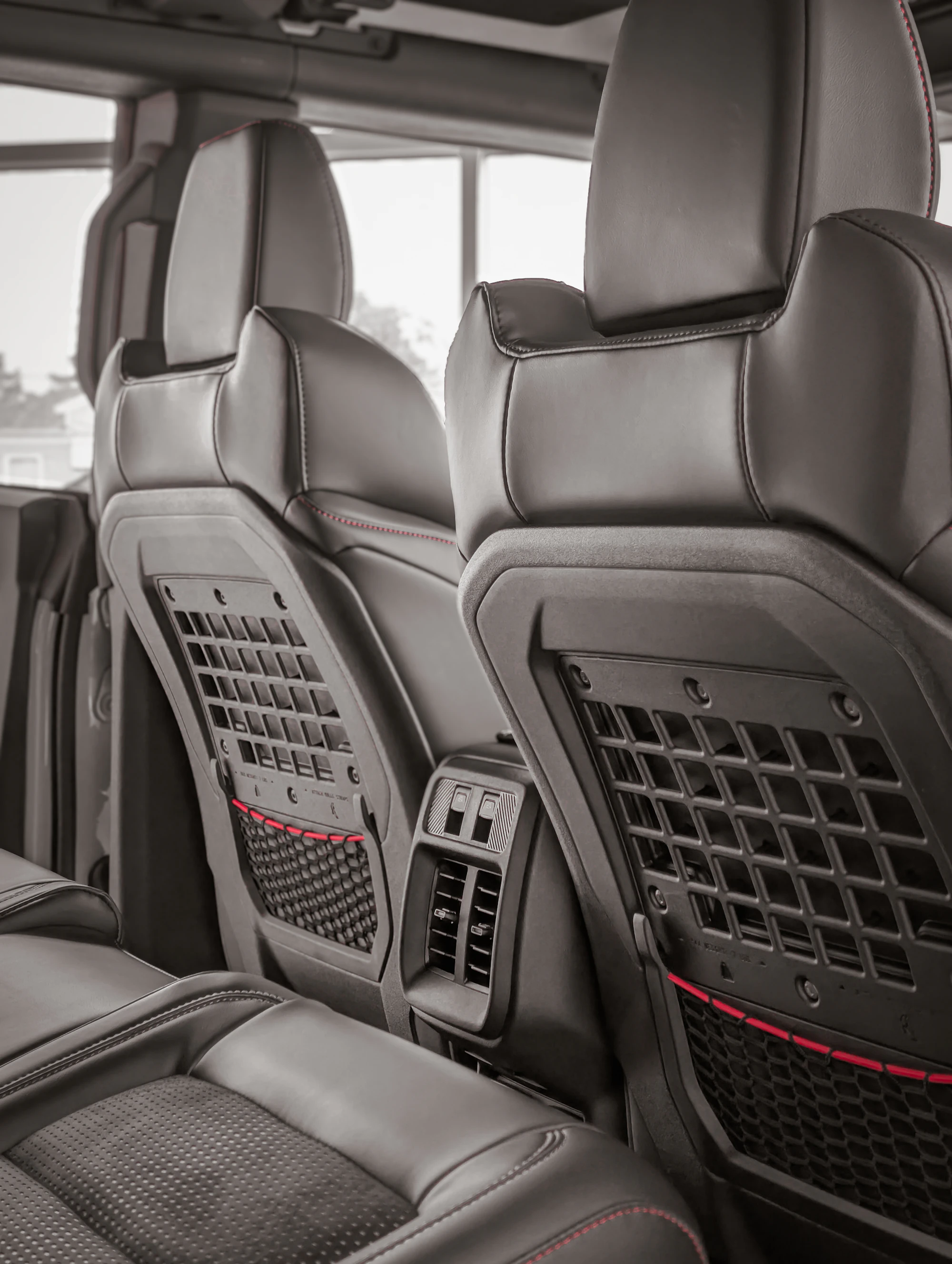 Real vehicle rear cabin with seatback storage and organized passenger space