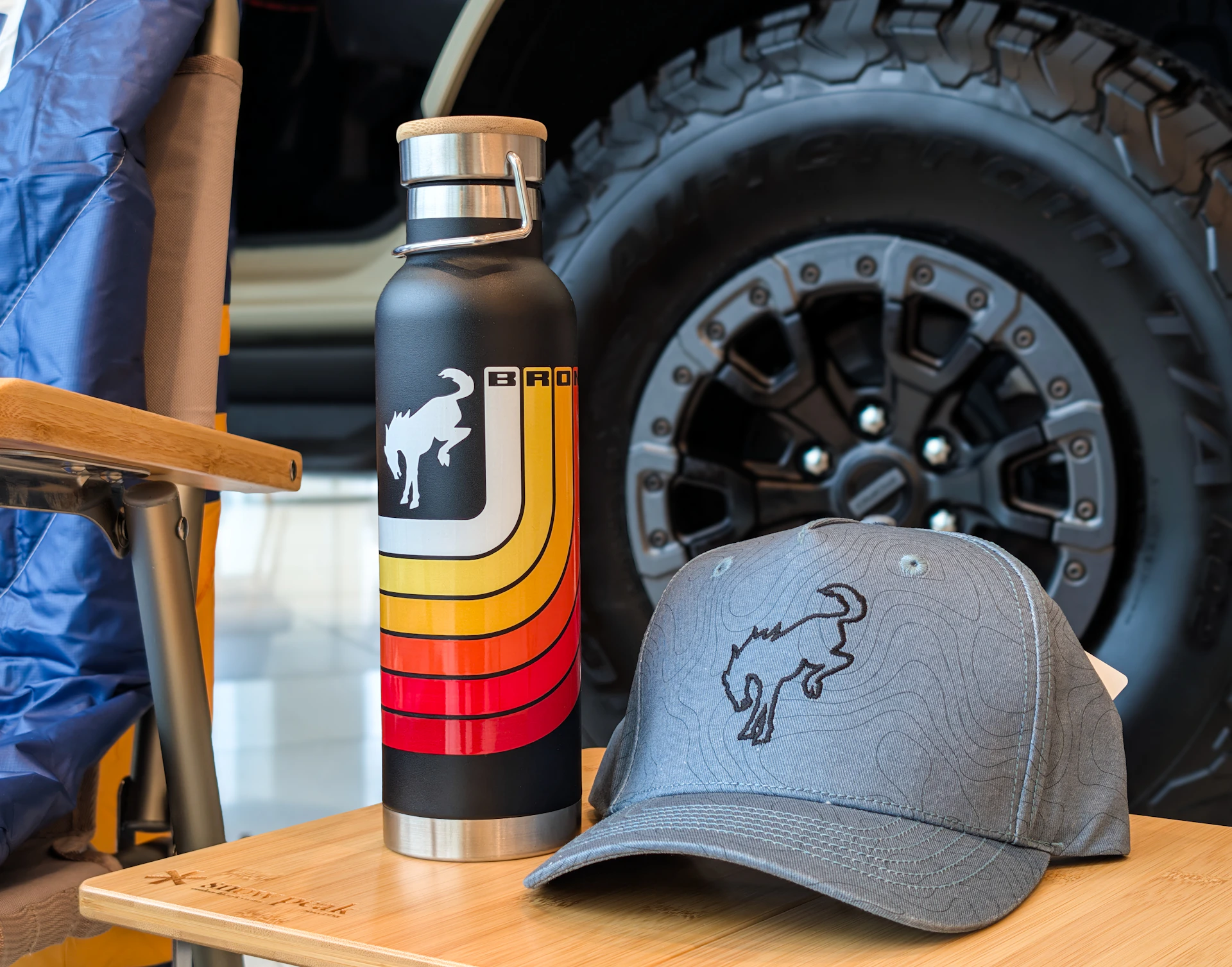 Black water bottle and grey cap with bronco logo.