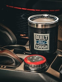 Black tumbler with ford tough logo in car