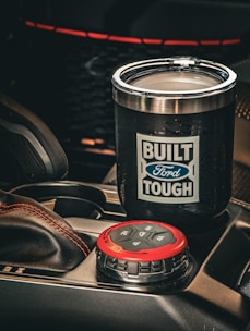 Black tumbler with ford tough logo in car