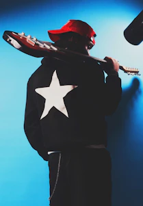 Musician with guitar and star jacket