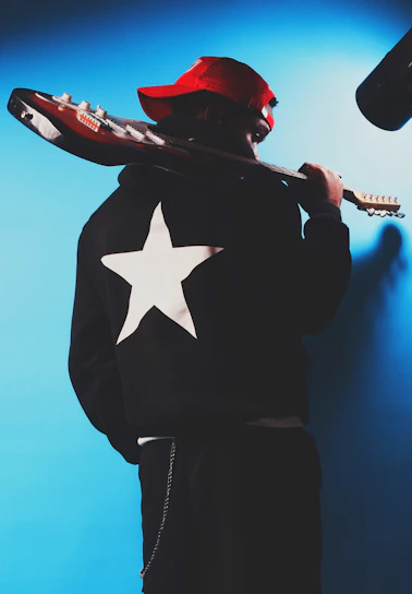 Musician with guitar and star jacket