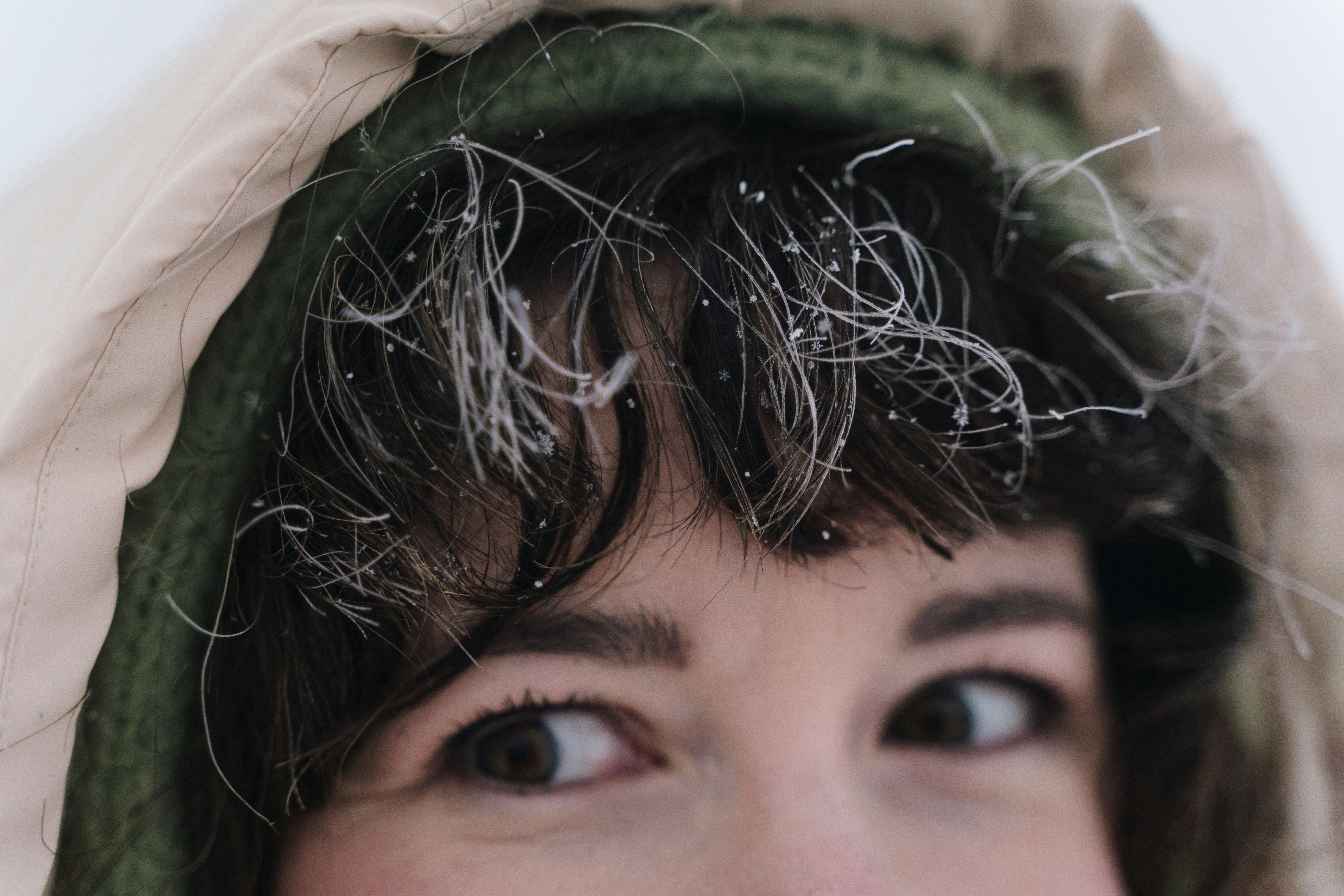Close-up of a woman's face with frost in her hair.