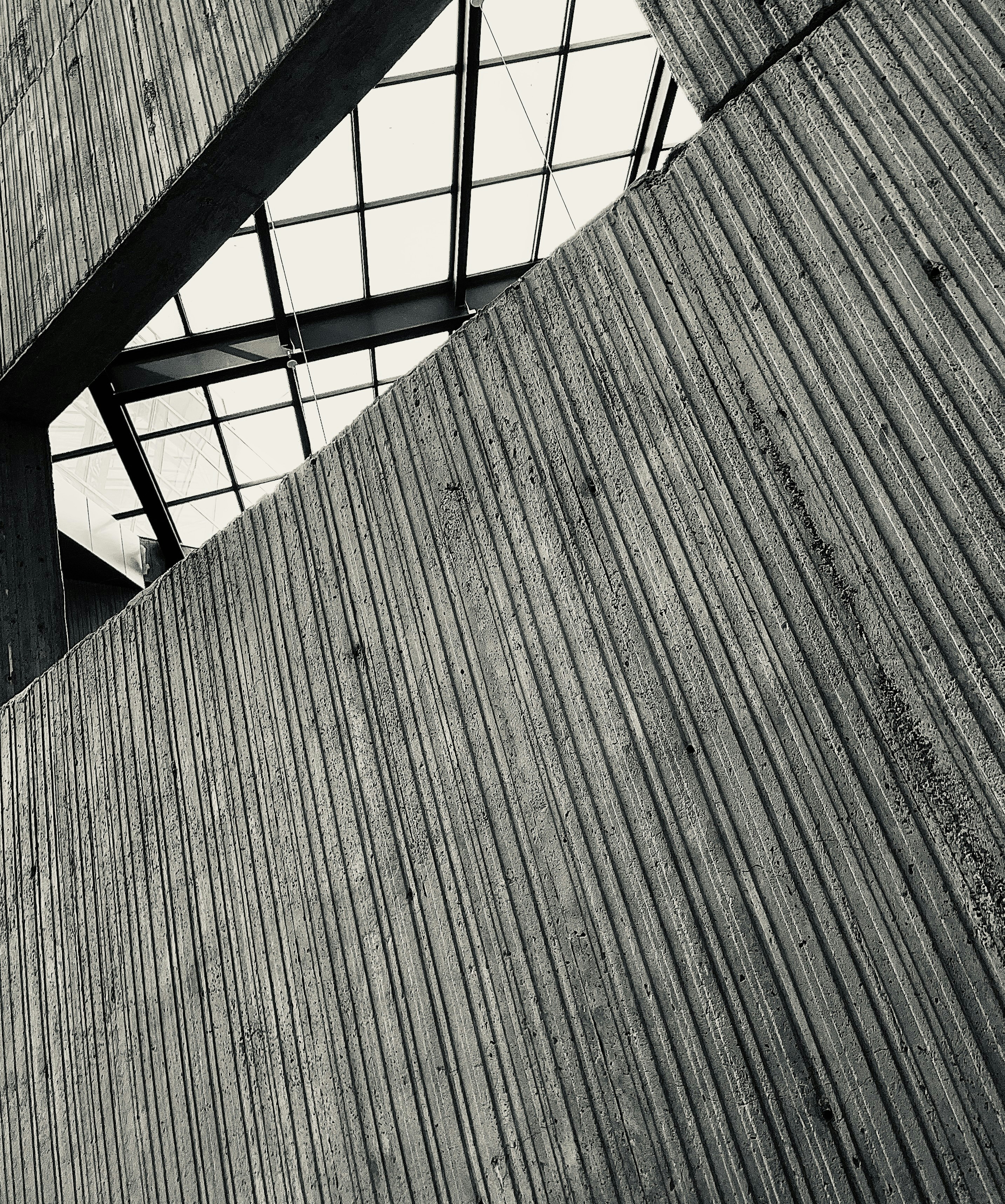 Abstract architectural detail with textured concrete and glass