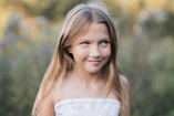 Young girl with blonde hair in a field