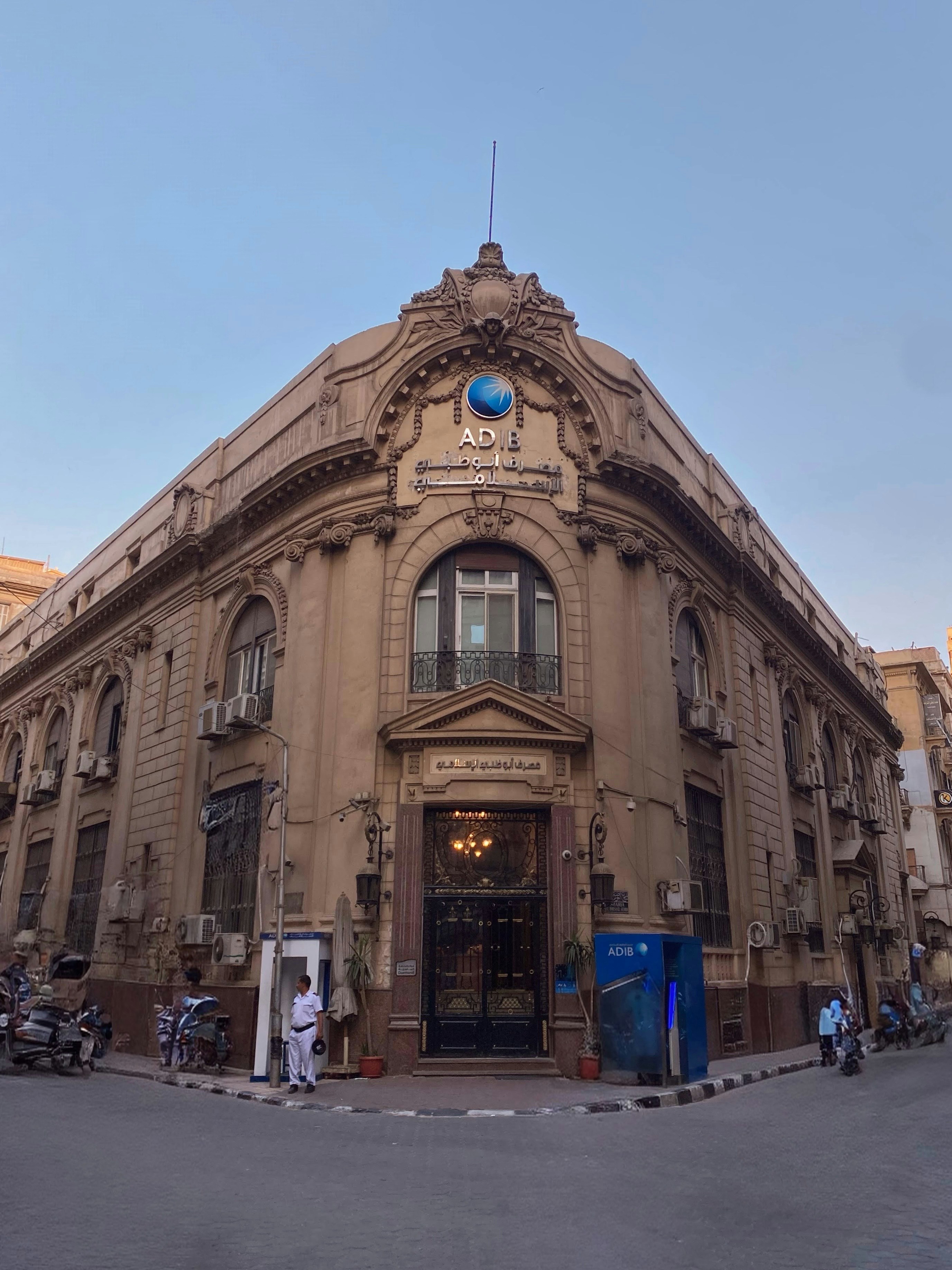 Ornate building with classical architecture on a street corner.