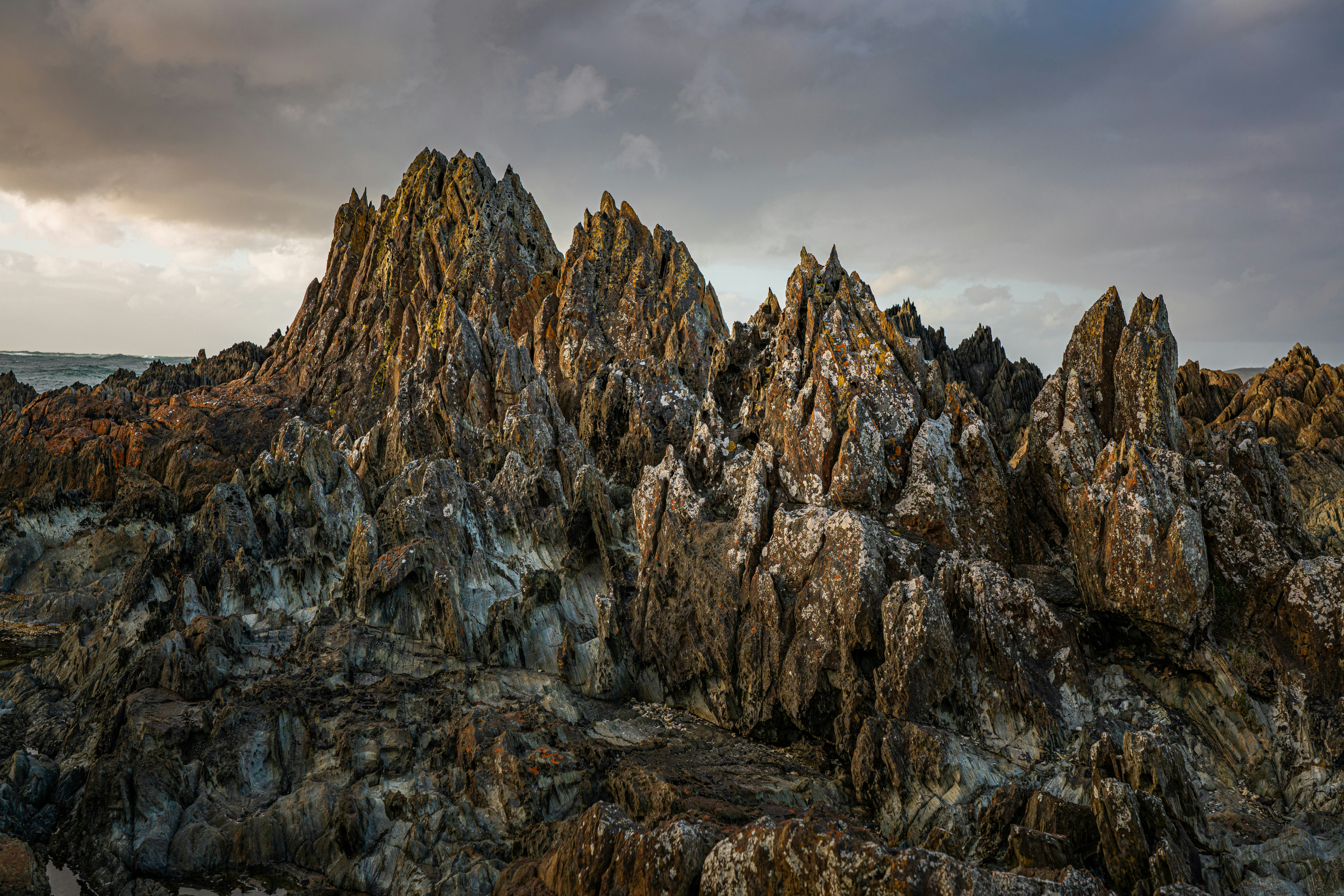 Jagged rocky coastline under a dramatic sky