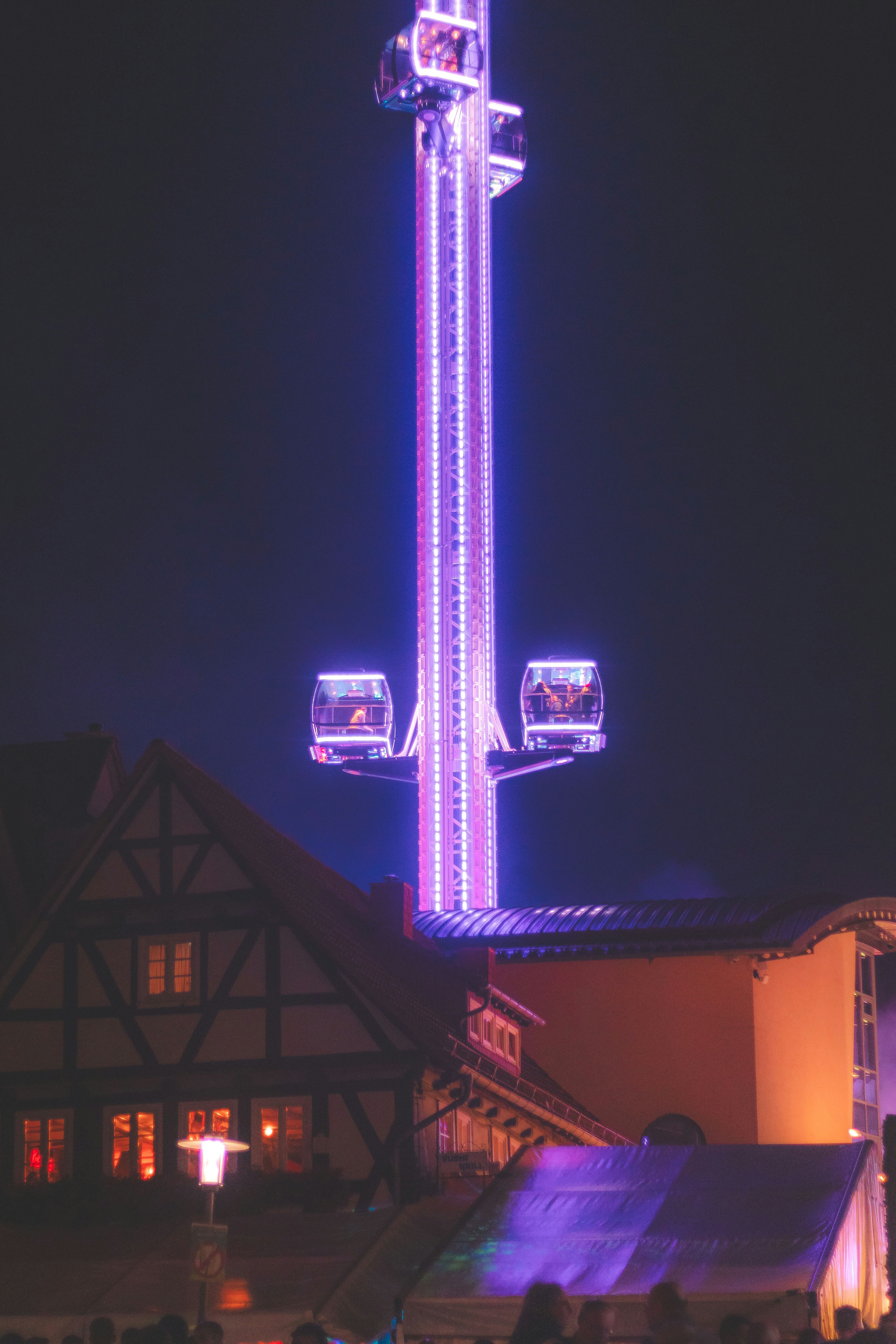Amusement park drop tower ride at night