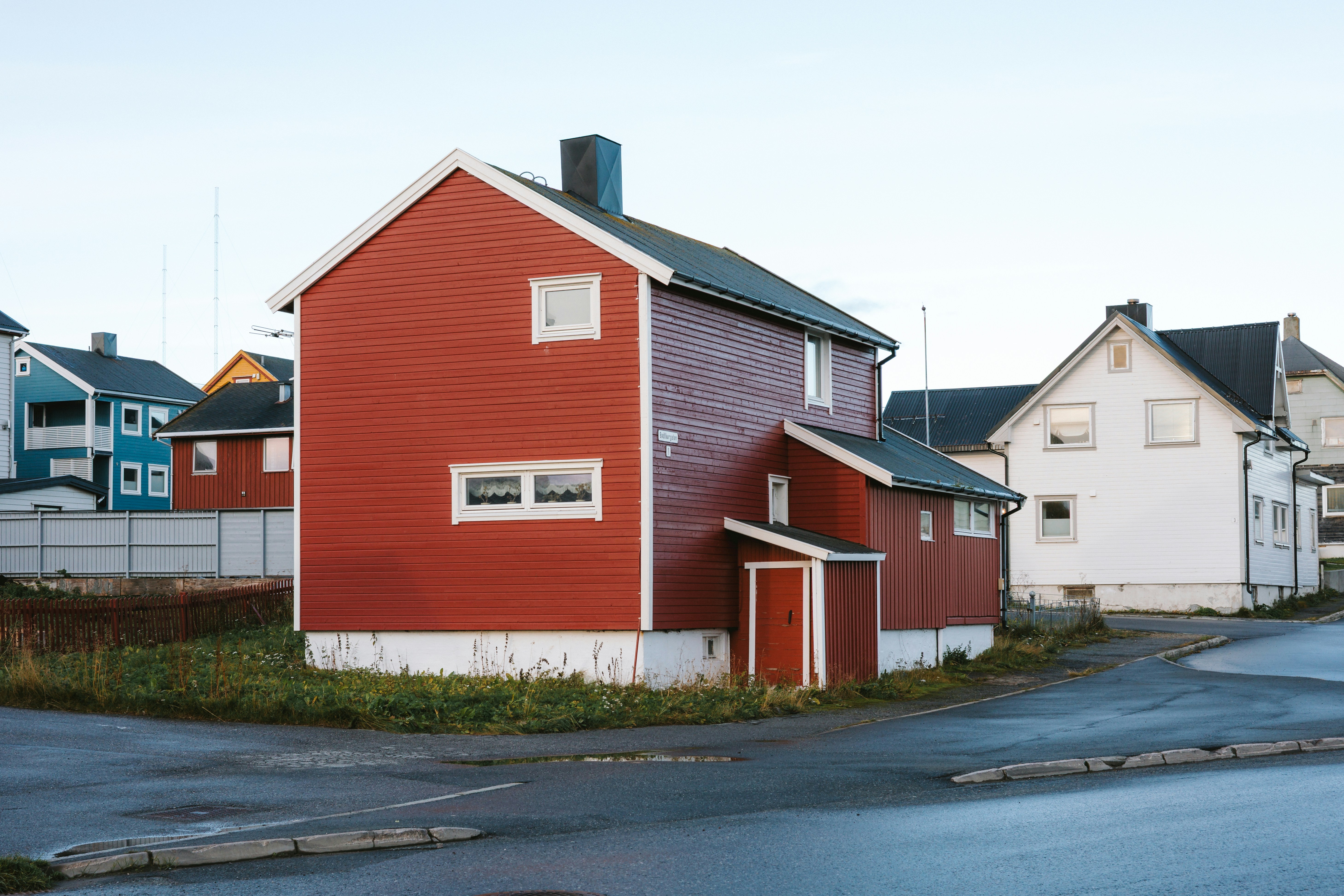 Red and white houses on a street corner