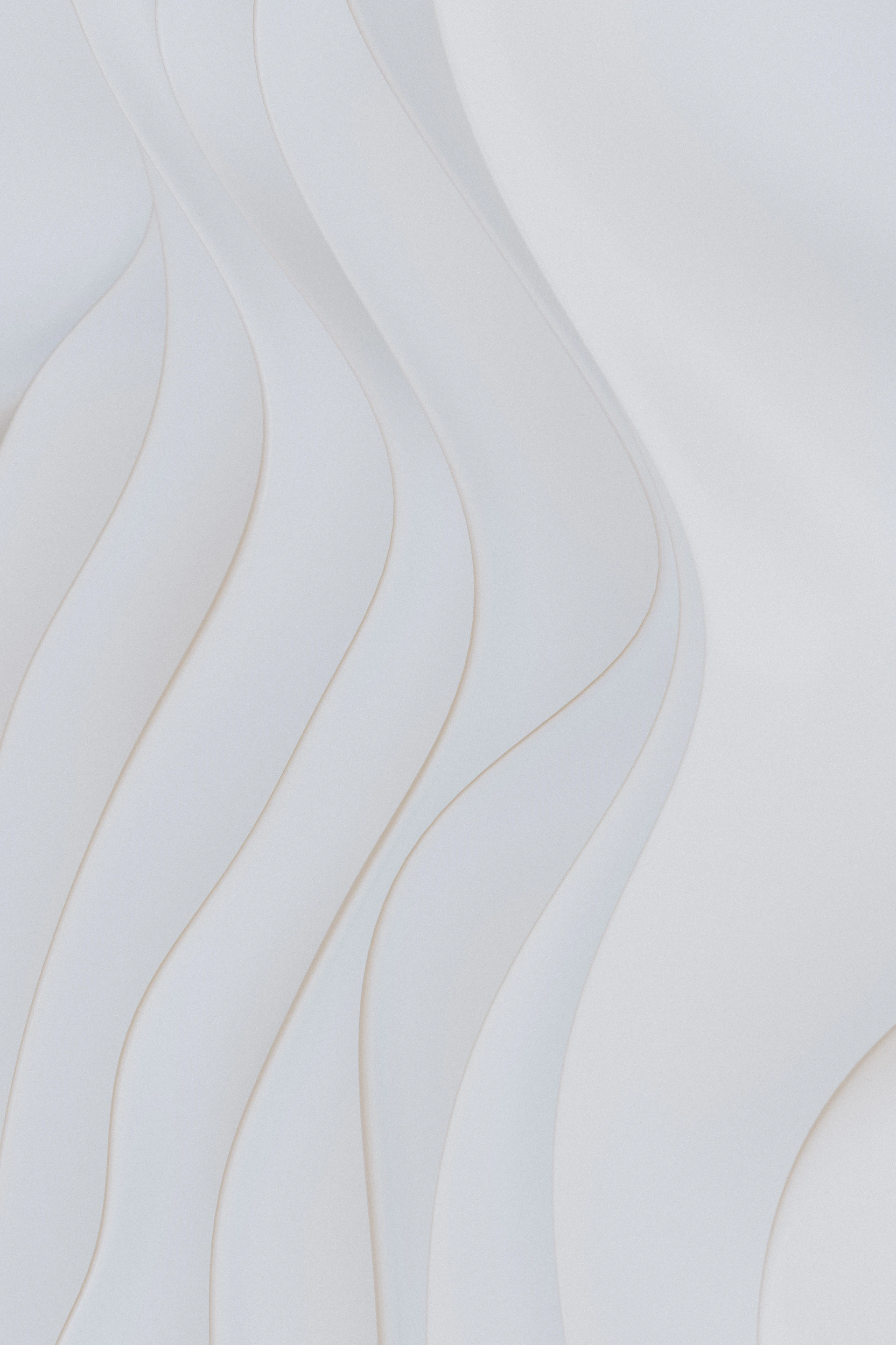 Abstract white wavy shapes with subtle shadows