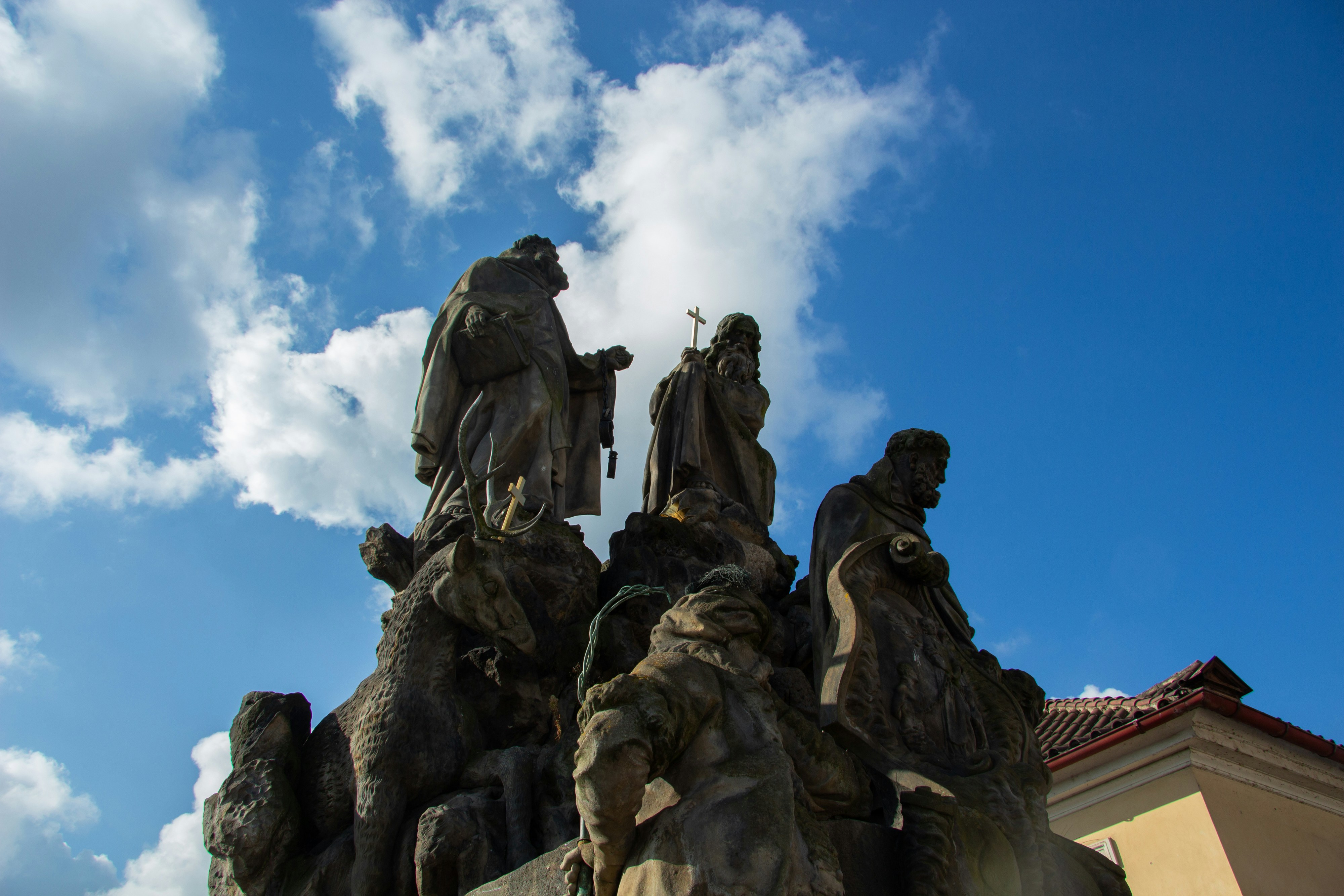 Statues against a cloudy blue sky