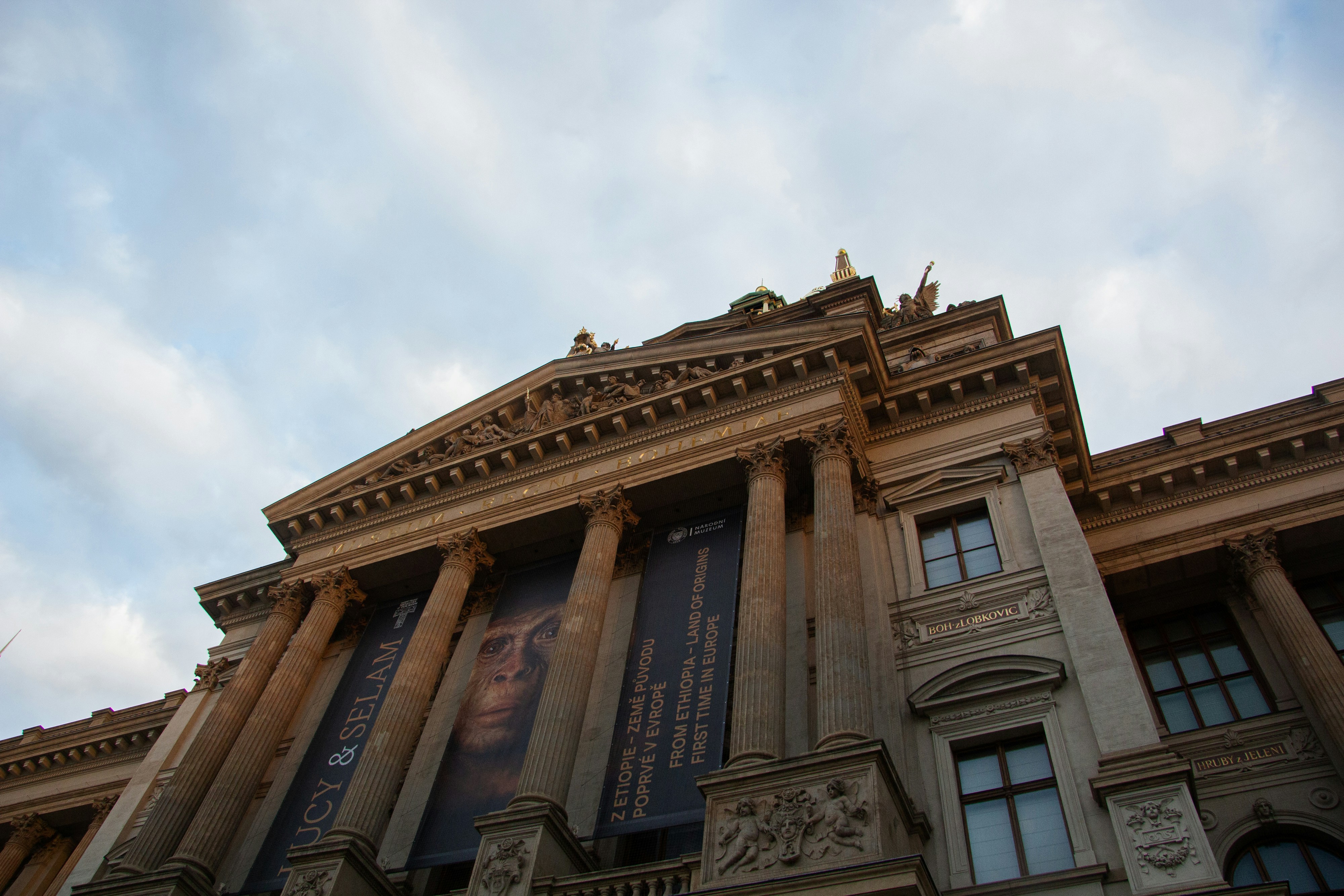 Grand building with columns and banners under sky