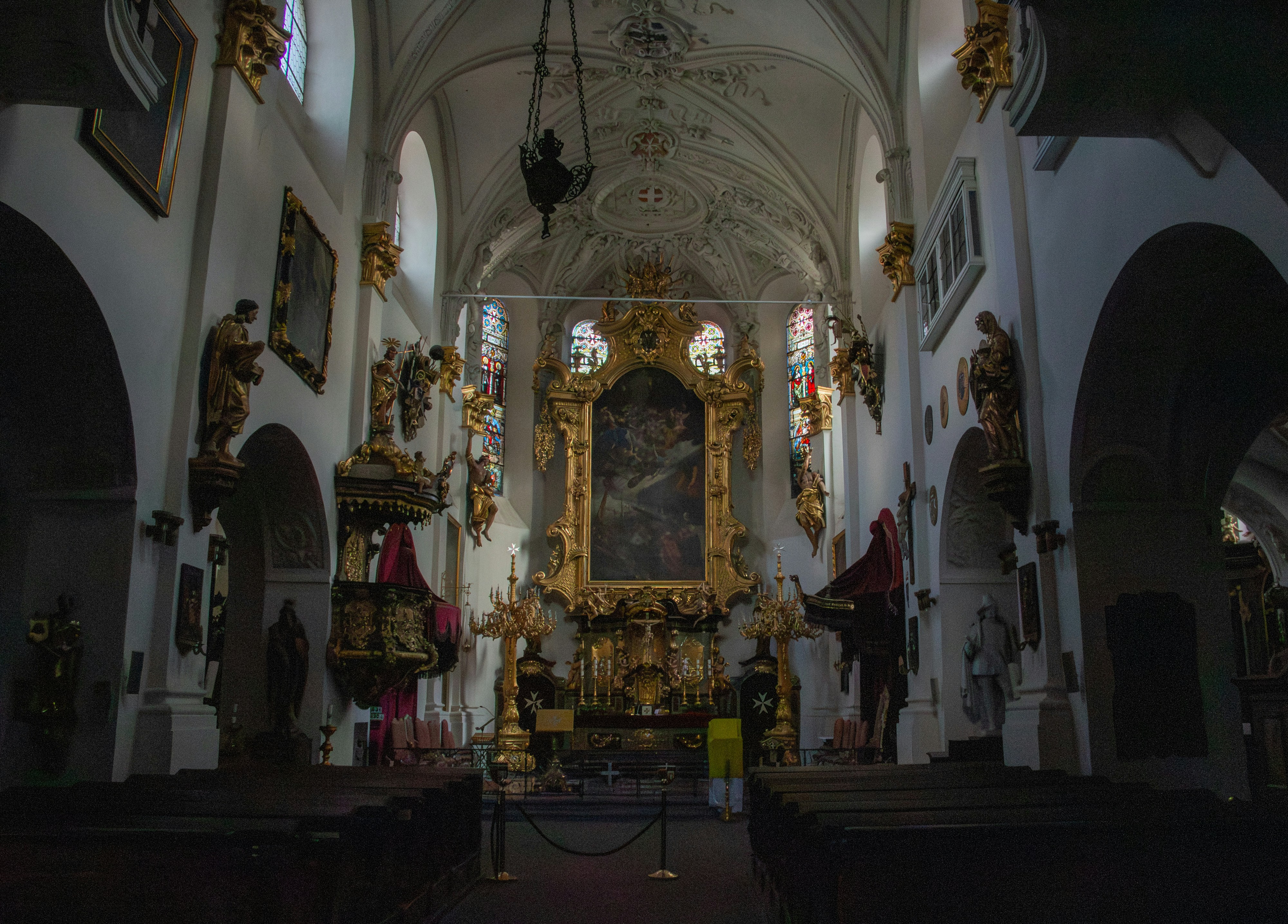 Interior of a grand church with ornate altar