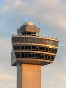 Air traffic control tower against a cloudy sky