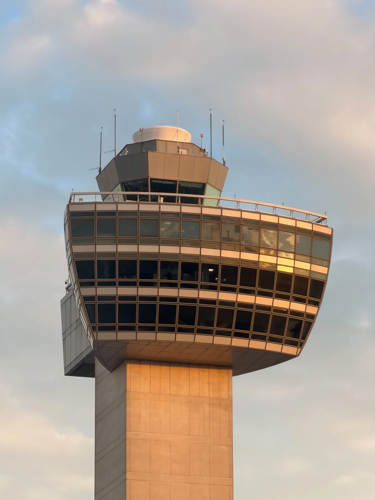 Air traffic control tower against a cloudy sky