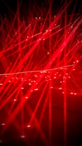Red laser lights creating a vibrant abstract pattern