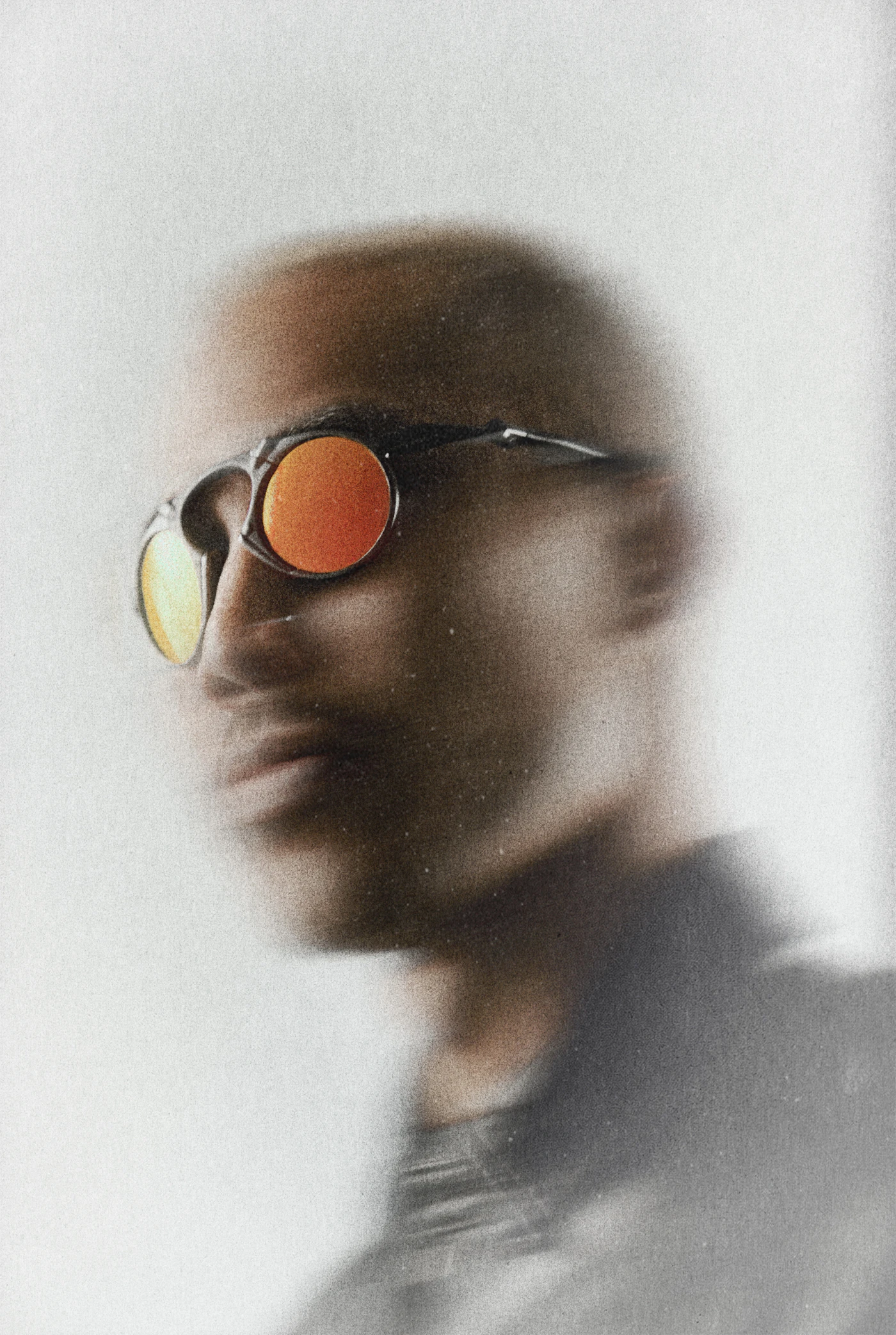A person wearing sunglasses with bright orange lenses