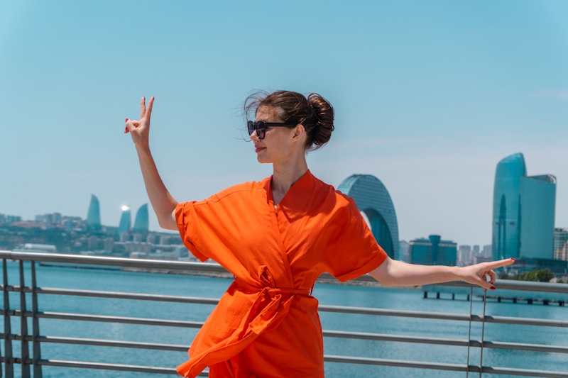 Glamorous woman in vibrant outfit with urban backdrop