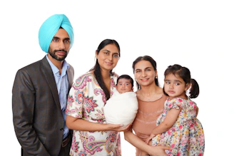 A sikh man, two women, and two children
