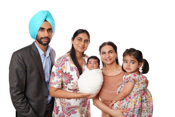 A sikh man, two women, and two children