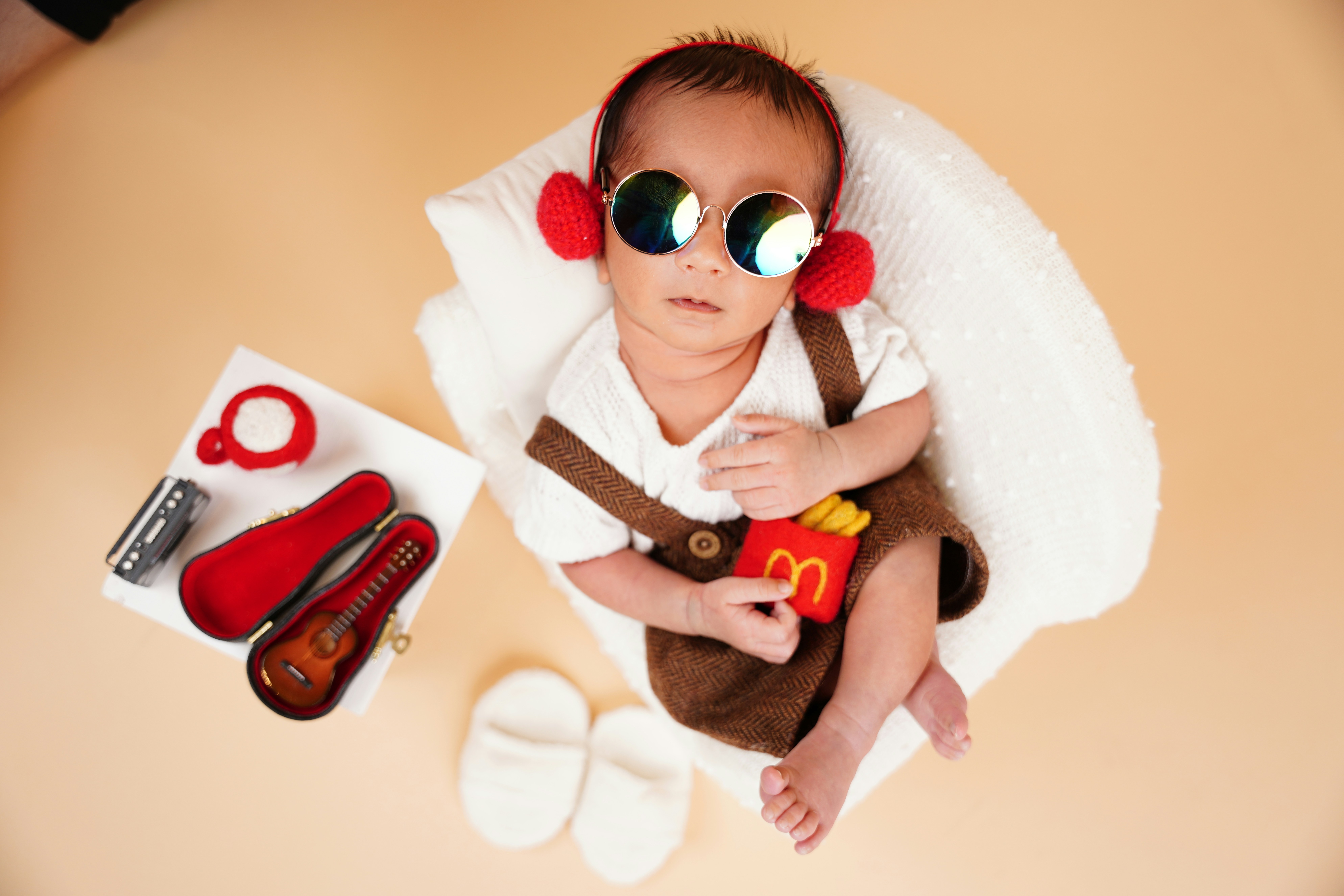 Baby wearing sunglasses and holding mcdonald's fries