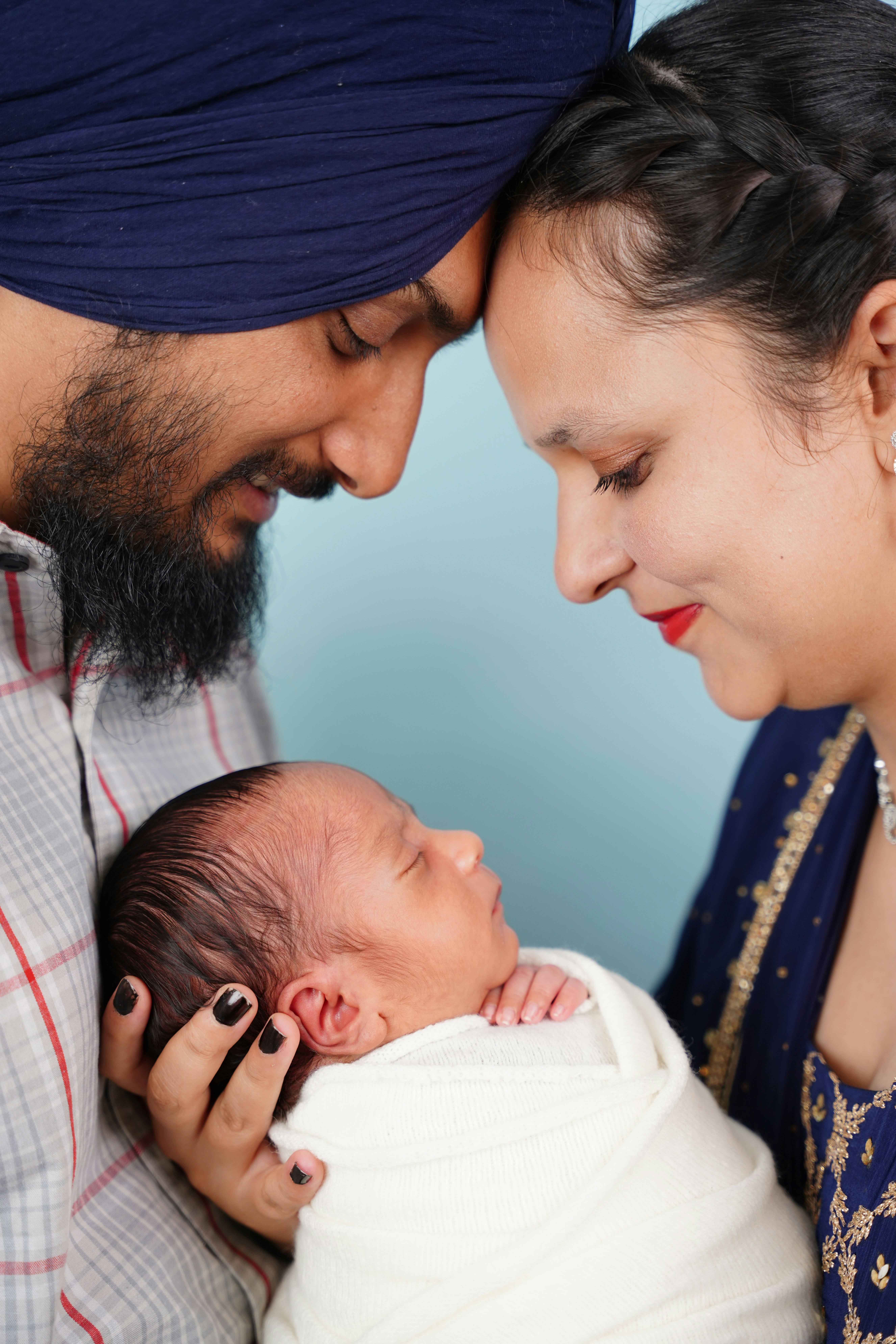 Parents cradle their newborn baby with love