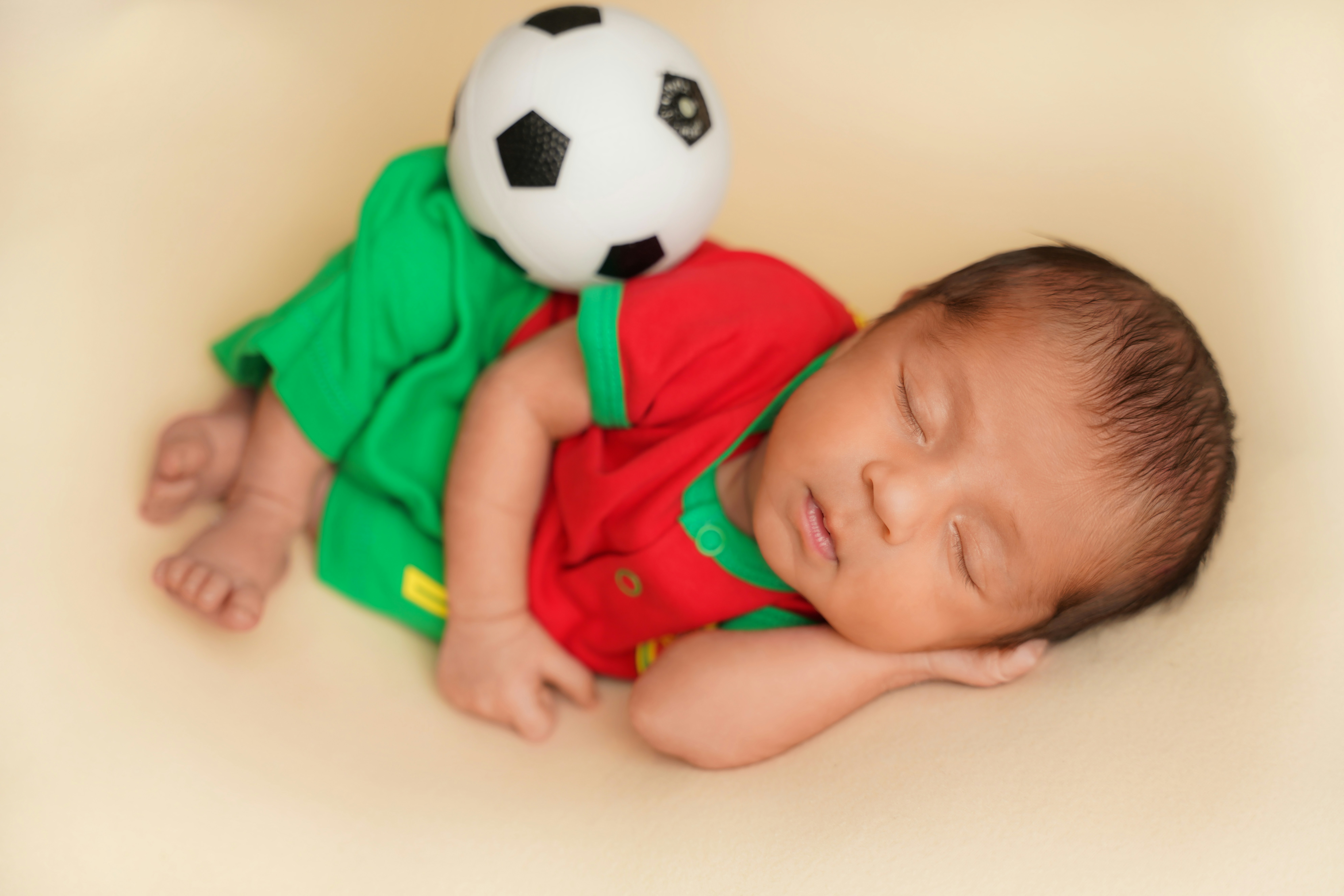 Baby in a football onesie cheering