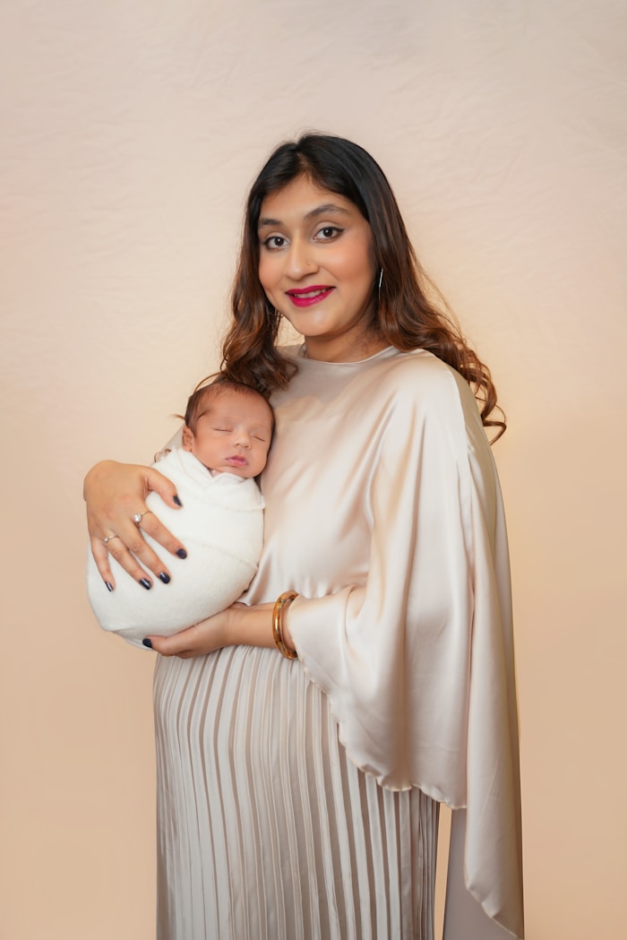 Mother holding swaddled newborn baby