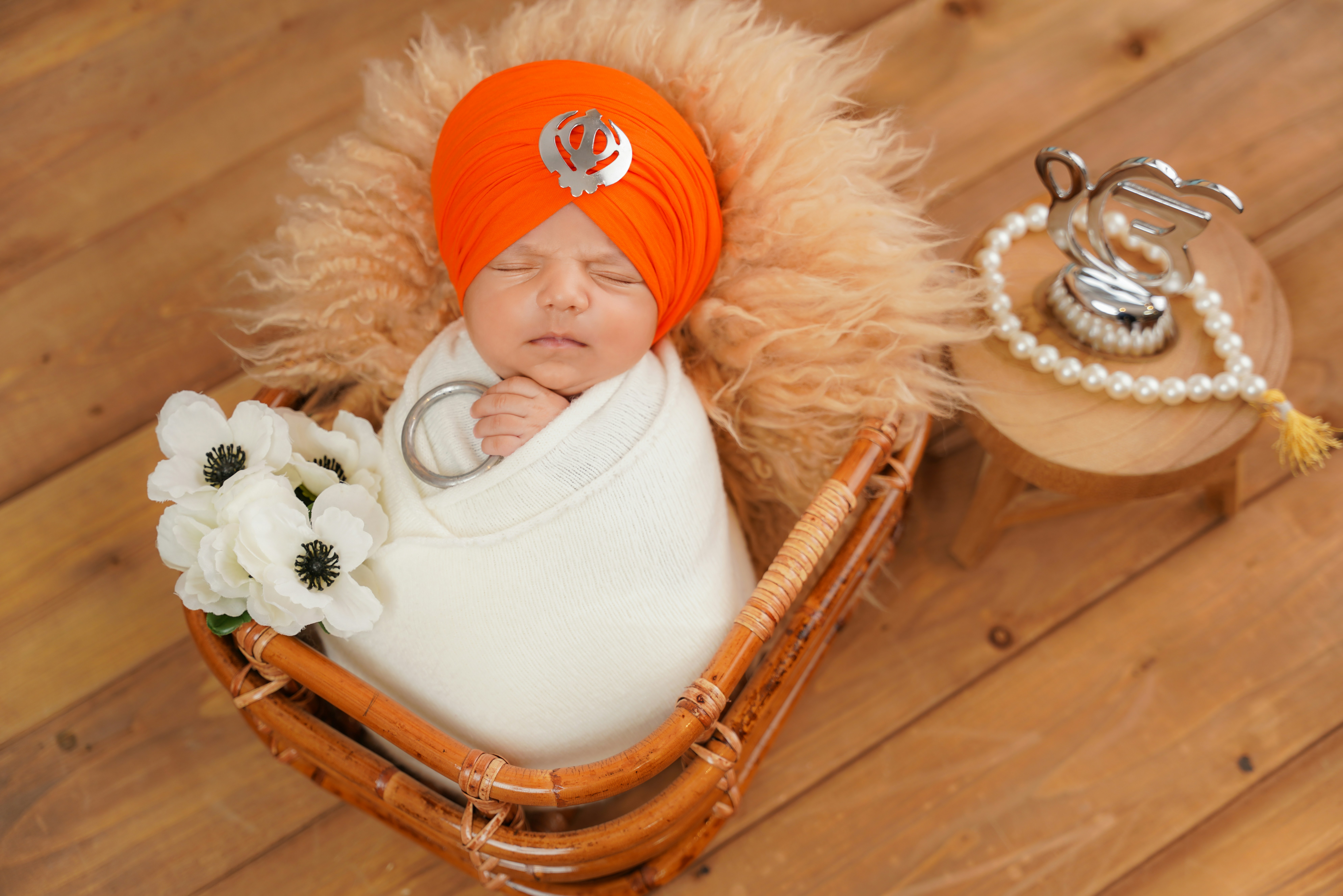 Newborn baby wrapped in a turban and blanket.