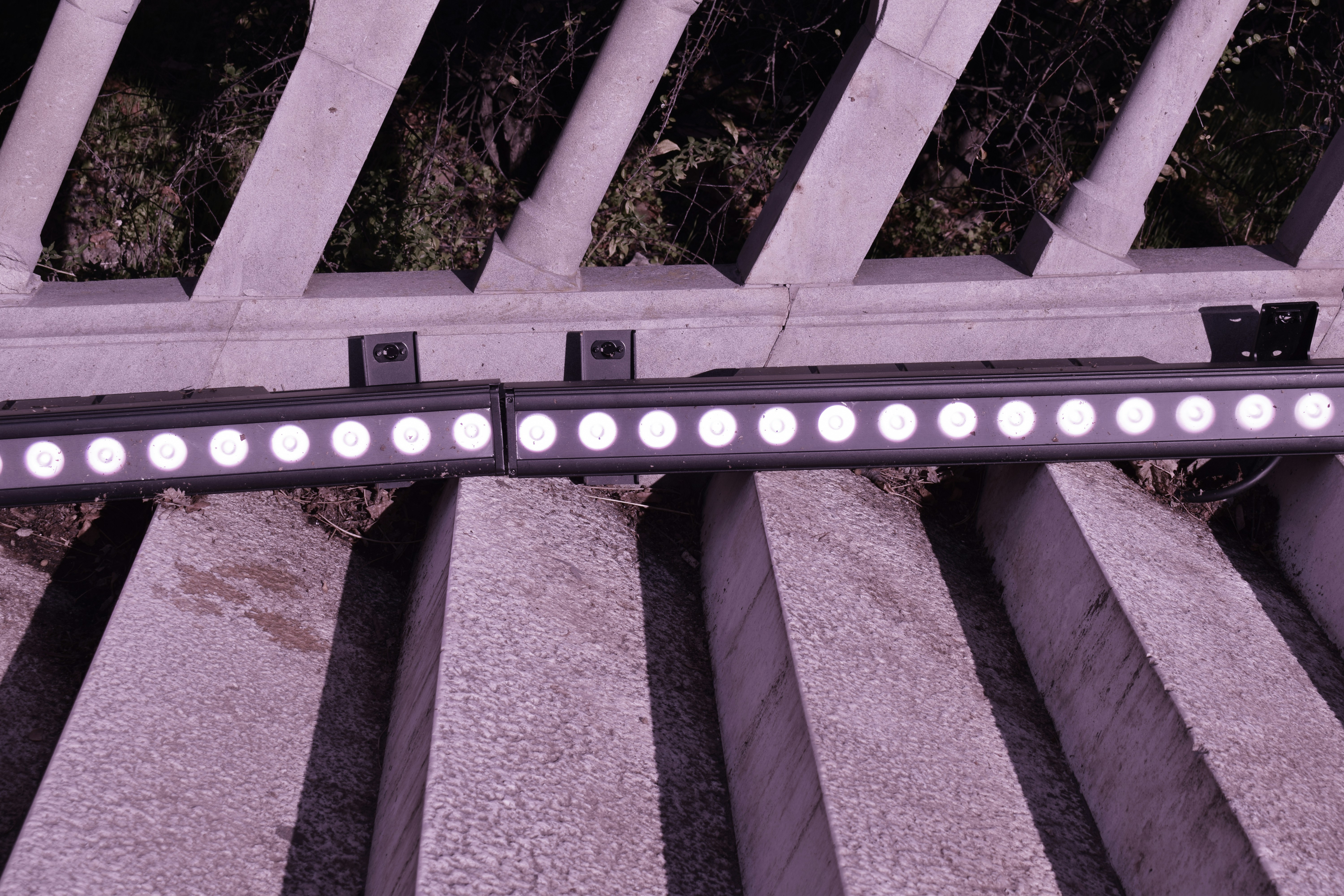Two linear led lights mounted on a railing.