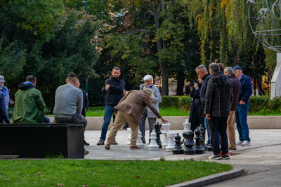 People playing giant chess in a park.
