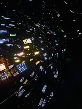Abstract network of glowing screens in darkness