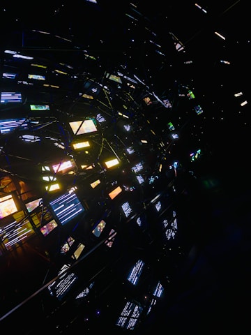 Abstract network of glowing screens in darkness