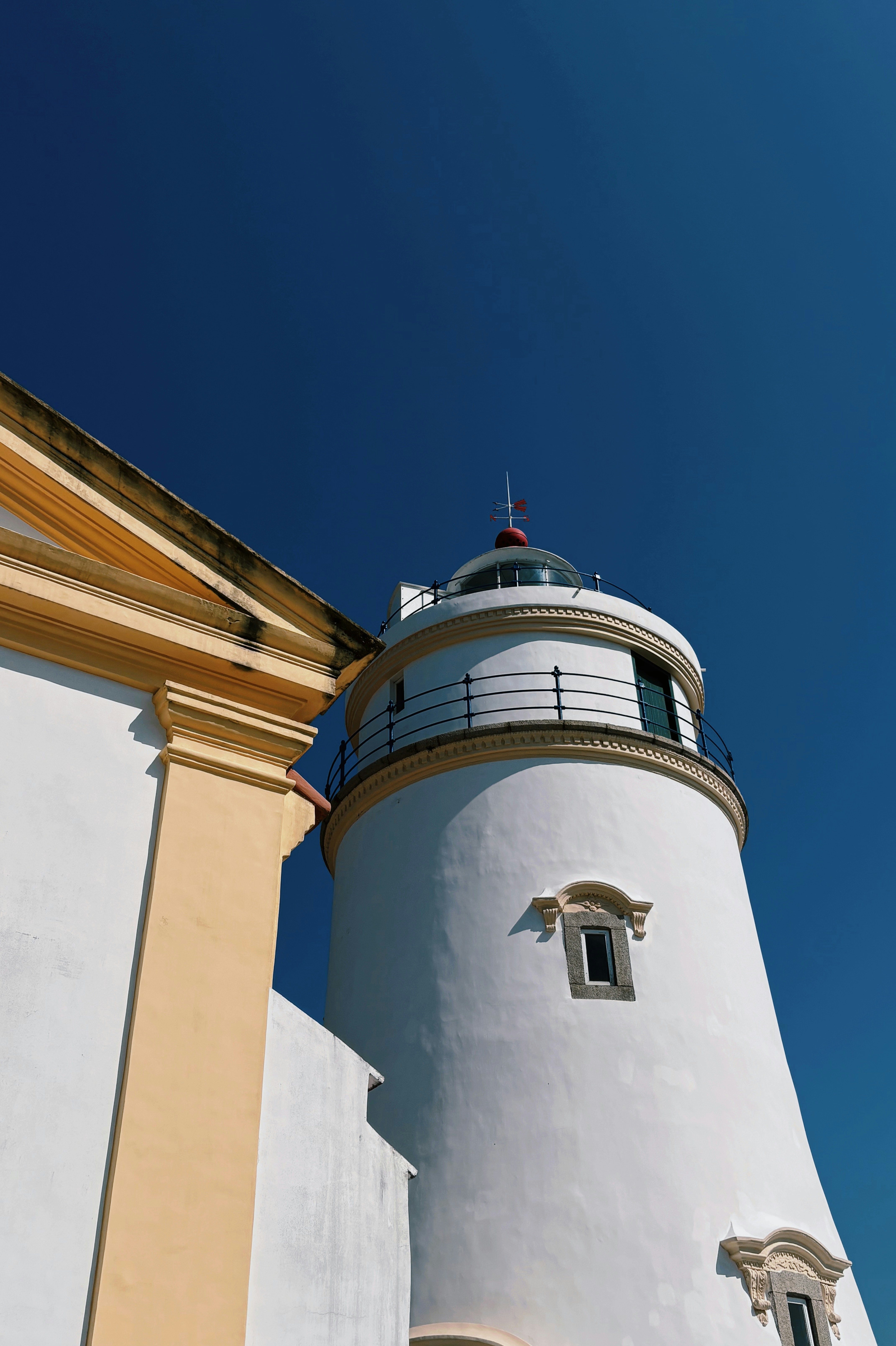 White lighthouse against a clear blue sky