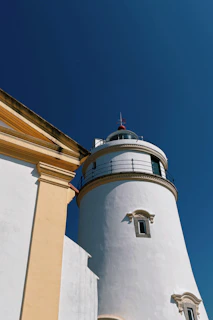 White lighthouse against a clear blue sky