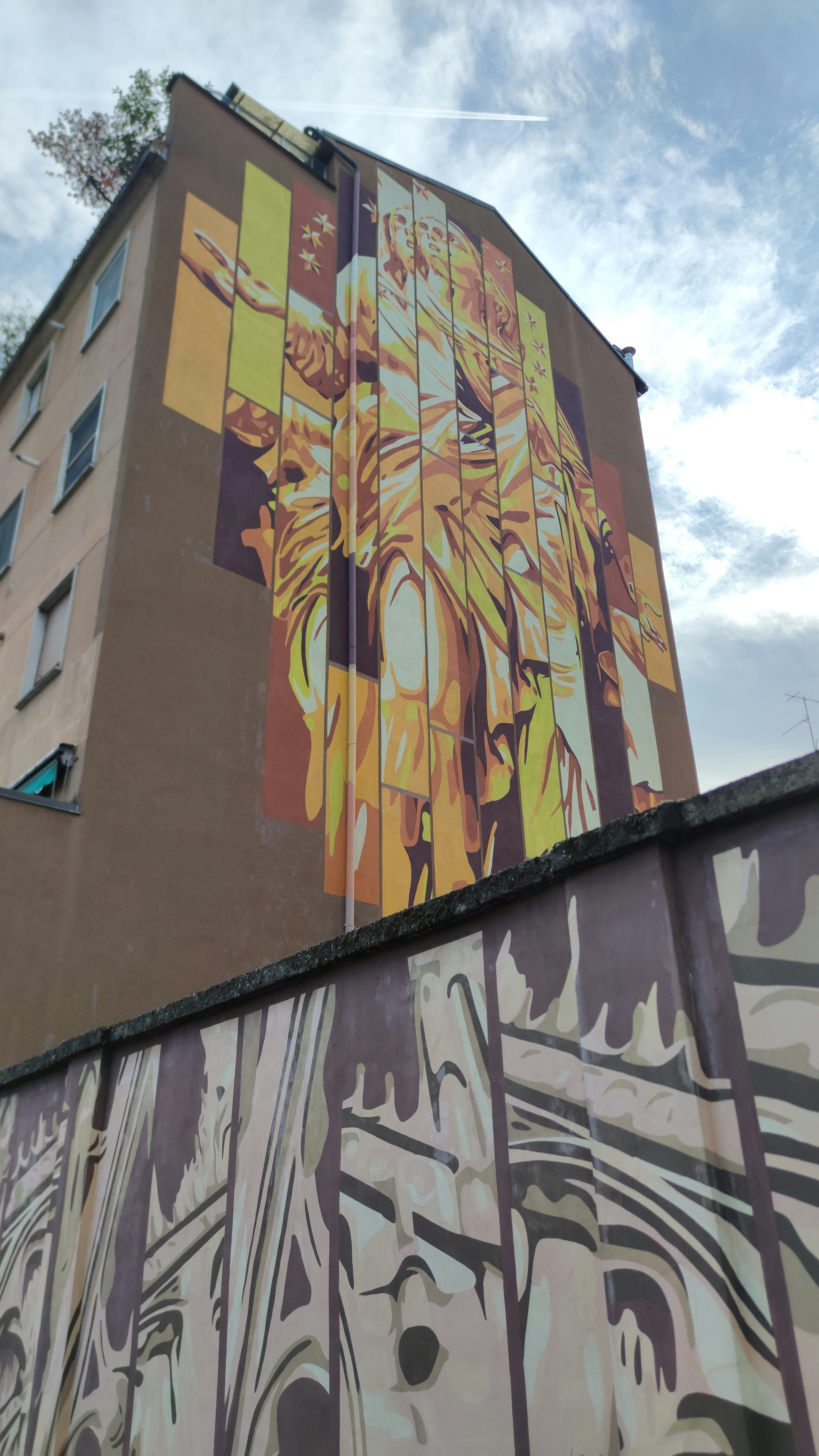 Building with large mural art and graffiti wall.