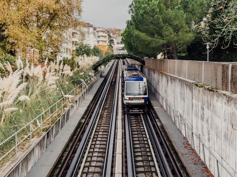 Elevated metro train moving through a city, representing Namma Metro Phase 3 expansion
