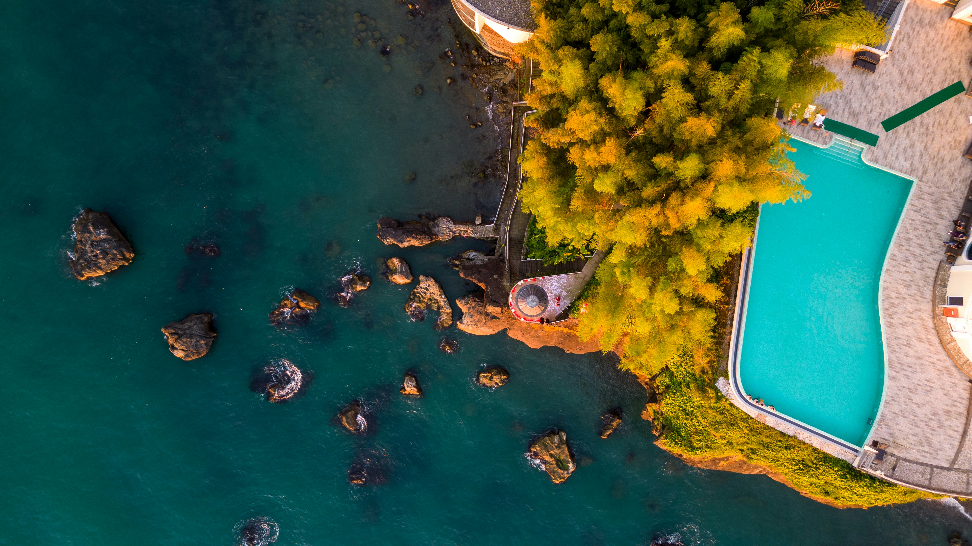 Aerial view of a resort pool by the ocean