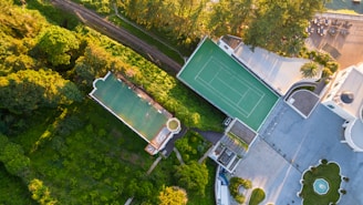 Aerial view of a mansion with pool and tennis court