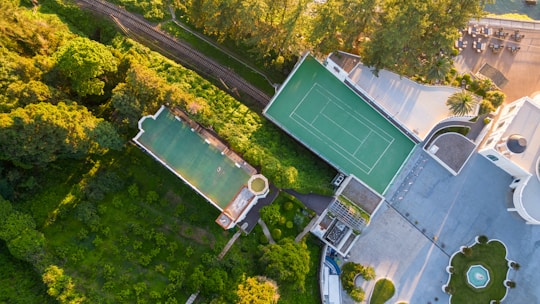 Aerial view of a mansion with pool and tennis court