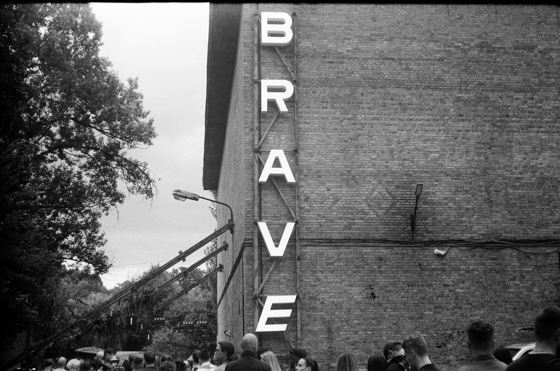 Large letters spell out brave on brick building