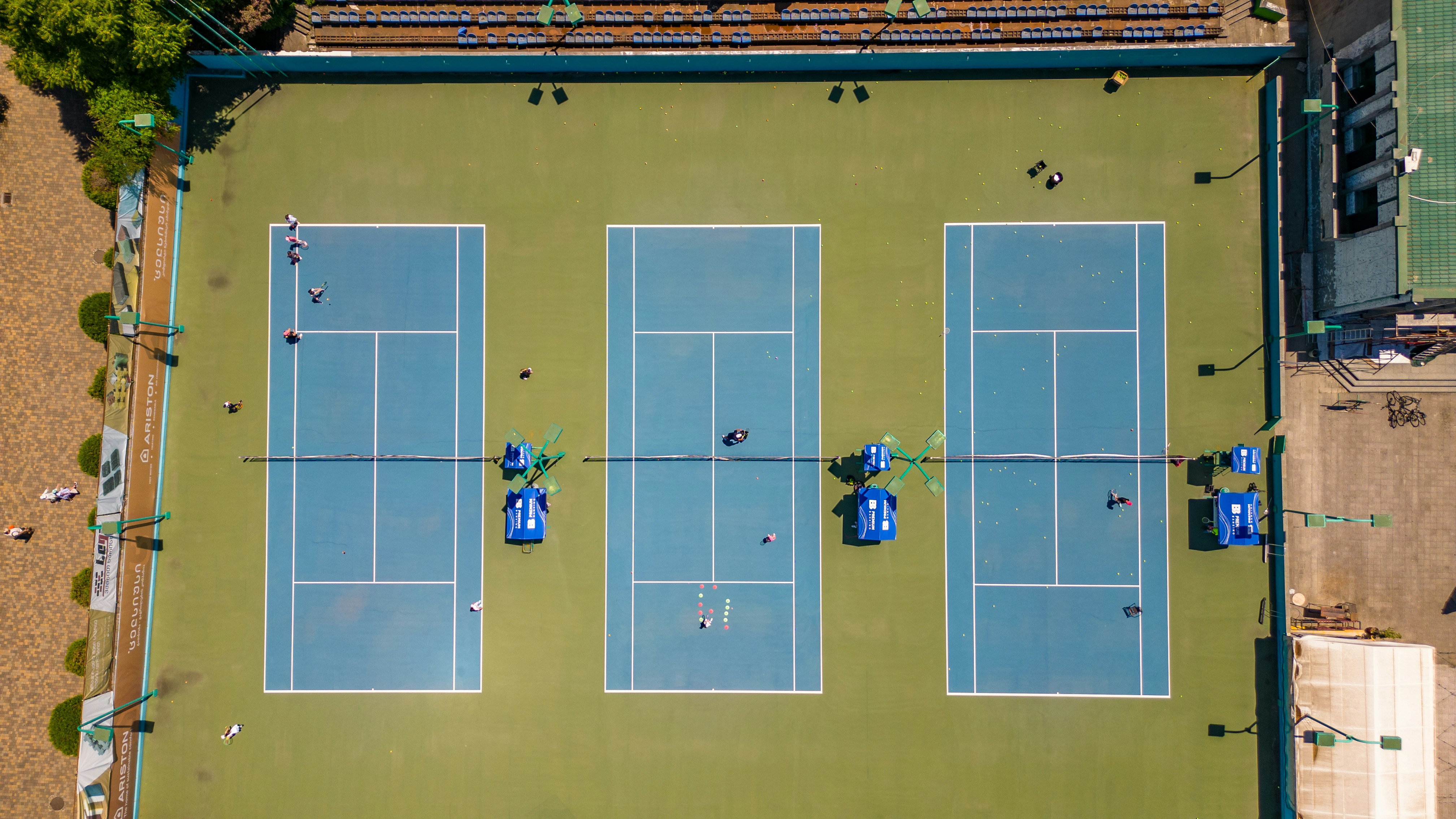 Aerial view of three blue tennis courts
